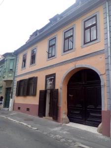 a building with an archway and a building at Pensiunea Central Sibiu in Sibiu