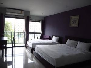 a hotel room with two beds and a balcony at The Sun Terrace in Chiang Mai