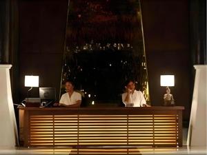 two men sitting at a desk in front of a mirror at Chivaree Hotel and Resort in Ban Mu Dut +290 photos