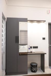 a kitchen with a counter and a refrigerator at Venetus Beach Residence in Varkala +6 photos