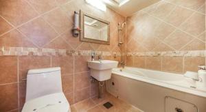 a bathroom with a toilet and a sink and a tub at Cinema Motel in Daejeon +62 photos