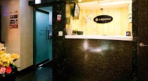 a door to a bathroom with a sign on the wall at Arioso Motel in Seryu-dong