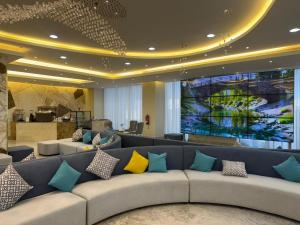 a lobby with a large couch with colorful pillows at Best Western Premier in Riyadh