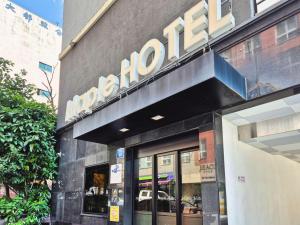 a store with a sign on the side of a building at Jeju Maple Hotel in Jeju