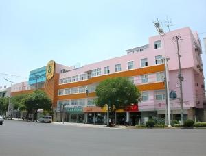 a large building on a street in front of a street at Super 8 Hotel Premier Suzhou Shihu Dong Road Metro Station in Suzhou