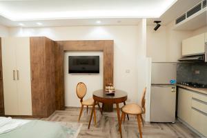 a kitchen with a table and chairs in a room at Aurora sky view suite in Sheikh Zayed