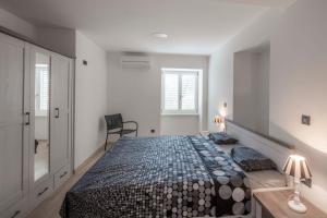 Posteľ alebo postele v izbe v ubytovaní Apartments Villa Adrienne