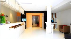 a living room with a kitchen and a hallway at Jinjiang Inn Sanya Jiefang Road Tax Free Shopping Center in Sanya