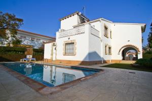 a large white house with a swimming pool in front of it at Supreme Planet Costa Dorada in Cambrils