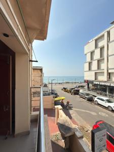 a balcony of a building with a view of the beach at The Maanvik Shores Luxury Home Stay - RK Beach in Visakhapatnam +73 photos