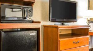 a kitchen with a microwave and a television and a refrigerator at Quality Inn in Sidney