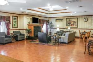 a living room with couches and chairs and a fireplace at Quality Inn & Suites Ann Arbor Hwy 23 in Ann Arbor