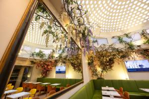 a restaurant with tables and chairs and a large window at Genius Hotel Downtown in Milan