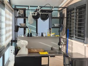 a kitchen with a sink and a counter with pots and pans at בית המזל Fortune House in Bet Sheʼan