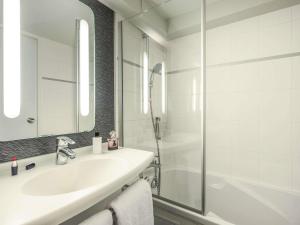 a white bathroom with a sink and a shower at ibis Paris Bastille Faubourg St Antoine in Paris