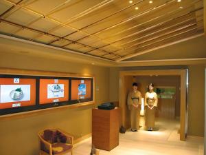 two men and a child standing in a room at Gunma Royal Hotel in Maebashi