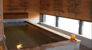 an empty room with two windows and a pool of water at Auberge Kitano Dandan in Abashiri +116 photos