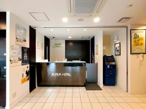 a store entrance with a cash counter in a building at Super Hotel Hofu-Ekimae in Hofu +172 photos