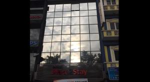 a large glass building with a sky in the window at Place2Stay @ The Mines in Serdang