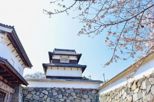 a building with a tower on top of a wall at ロジュマン博多 in Hakata