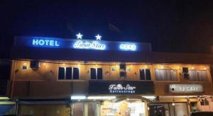 a hotel with a sign on top of it at night at Twin Star Hotel in Kampong Keteyong