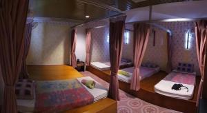 a bedroom with two bunk beds with pink curtains at Twin Star Hotel in Kampong Keteyong