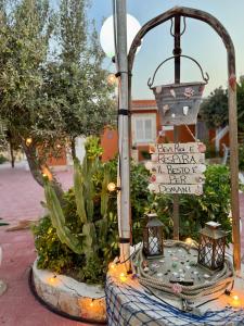 a street light with a street sign on it at Residence La Conchiglia in Lampedusa