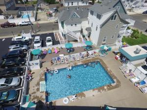 an aerial view of a swimming pool and a parking lot at Sand Pebble Motor Lodge in Point Pleasant Beach