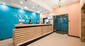a bar in a restaurant with a blue wall at Xana Lite Beijing West Station Branch in Beijing +7 photos