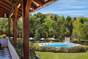 an outdoor view of a swimming pool in a yard at Bremen Hotel & Spa in Villa General Belgrano