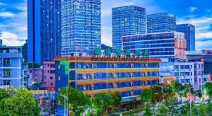 a city skyline with tall buildings and a building at City Comfort Inn Guangzhou Zengcheng Wanda Plaza Metro Station in Zengcheng
