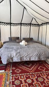 a bedroom with a bed in a tent at Bivouac Erg Chegaga Nomademoi in El Gouera