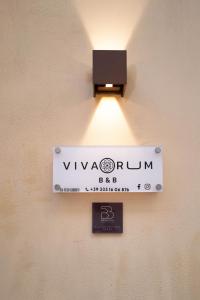 a sign on a wall with a light on it at Vivarum b&b in Bitonto