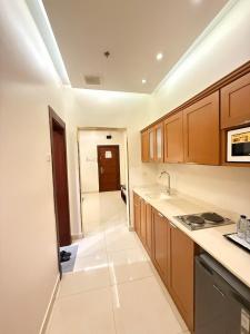 a kitchen with a sink and a stove top oven at نزل خيال للشقق المخدومه in Jazan