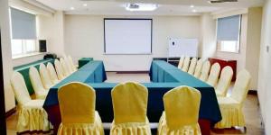a conference room with a blue table and chairs at James Joyce Coffetel Shijiazhuang the Mixc Xinbai Plaza Metro Station in Shijiazhuang