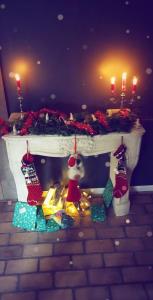 a table with christmas lights and candles on it at Unieke landelijke woning met zwembad in Kranenburg