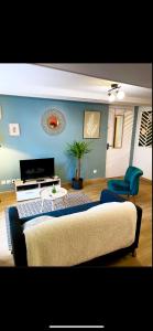 a living room with a couch and a chair at Le 5 étoiles du Cœur de ville in Dole