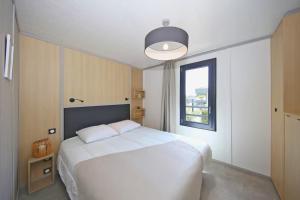 En eller flere senge i et værelse på Le Tranquillou