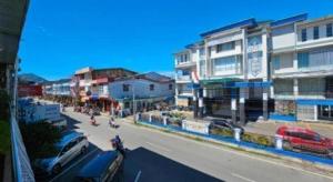 a city street with cars parked on the side of the road at Hotel Sinar Khatulistiwa in Singkawang
