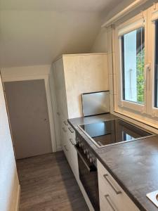 a kitchen with a counter top and a window at Anna's Appartement in Matten