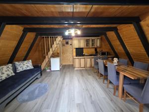 a living room with a couch and a table at Cabana Sofia in Burzeşti