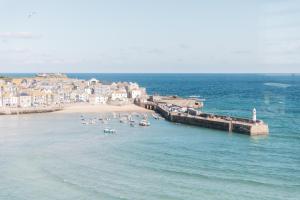 a group of people on a beach in the water at Harbour View House in St Ives