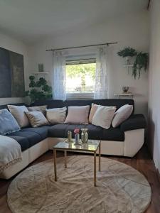 a living room with a couch and a table at Room Lovely in Rose resort in Ljubljana in Rove