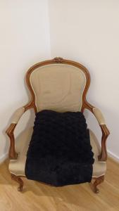a black blanket sitting on a chair in a room at Double Room Near EU, City Centre in Brussels