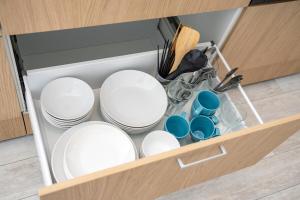 a drawer with white plates and dishes in it at シャングリラ沖縄 in Motobu