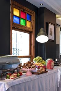 a table with a plate of food and a window at Rodosto Hotel in Tekirdağ