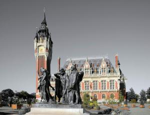 a statue in front of a building with a clock tower at Front de Mer in Calais +7 photos