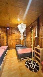 a bedroom with two beds and a lamp in it at Akimebonphuresort in Ban San Pu Loei (2)
