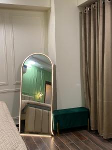 a mirror in the corner of a room at Luxury, Modern & Central Apartment Islamabad, with Gym, Near Motorway & Airport in Islamabad