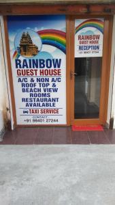 a sign for a restaurant with a rainbow and a rainbow guest house at Rainbow Guest House in Mahabalipuram